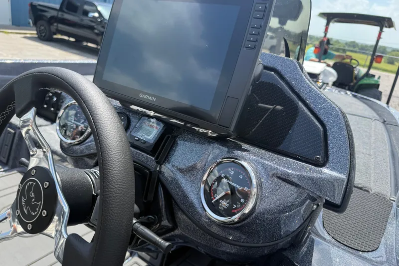 Slide: The Image of Dashboard of a 2027 Phoenix 921 Elite X boat with Garmin display and steering wheel. - 16