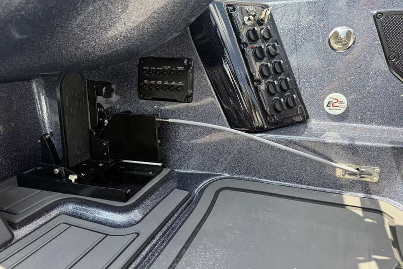 Slide: The Image of Interior controls of a 2027 Phoenix 921 Elite X boat, featuring foot pedal and switches. - 12