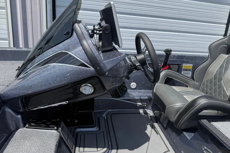 Slide: The Image of 2027 Phoenix 921 Elite X boat cockpit with steering wheel and modern dashboard. - 11