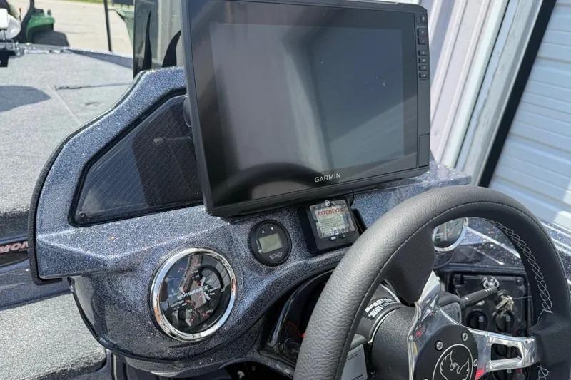 Slide: The Image of Dashboard of 2027 Phoenix 921 Elite X with Garmin display and steering wheel. - 15