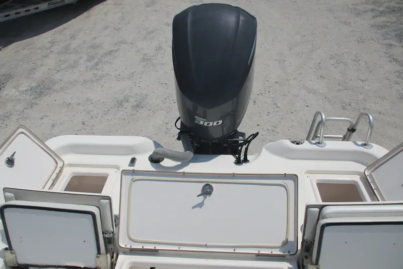 Slide: The Image of 2016 BLUEWAVE 24 Pure Bay boat with 300 horsepower engine, open storage compartments. - 5