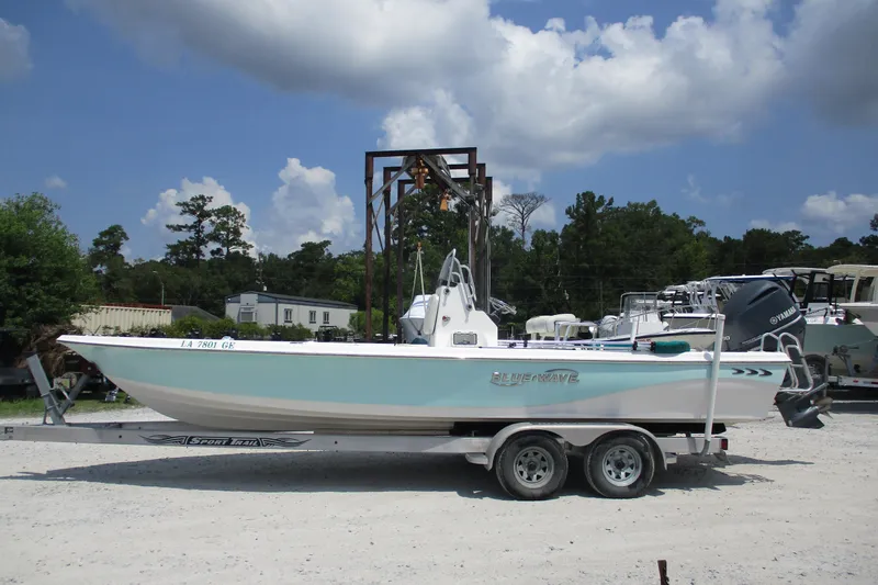The Image of 2016 BLUEWAVE 24 Pure Bay boat on trailer, parked outdoors under a cloudy sky. - 1