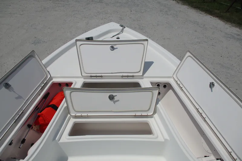 Slide: The Image of 2016 BLUEWAVE 24 Pure Bay boat with open storage compartments on deck. - 8