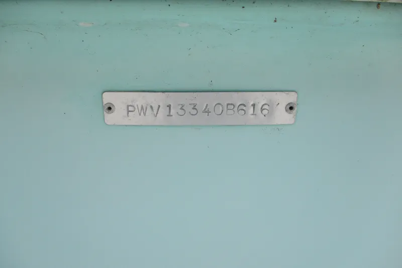 Slide: The Image of 2016 BLUEWAVE 24 Pure Bay boat identification plate on light blue surface. - 15