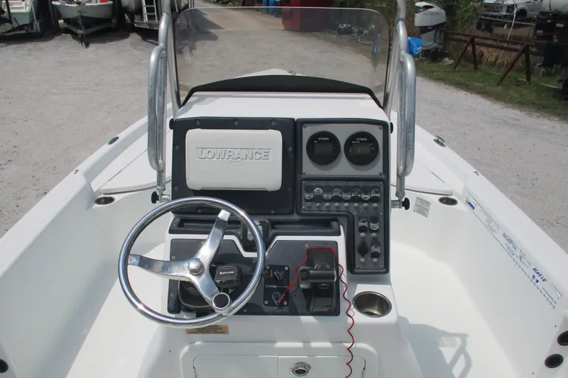 Slide: The Image of Center console of a 2016 BLUEWAVE 24 Pure Bay boat with steering wheel and controls. - 12