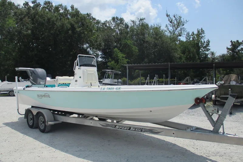 Slide: The Image of 2016 BLUEWAVE 24 Pure Bay boat on trailer, parked outdoors. - 9