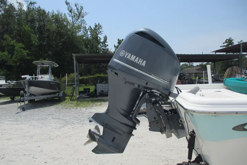 Slide: The Image of 2016 BLUEWAVE 24 Pure Bay boat with Yamaha outboard motor in a sunny outdoor setting. - 10