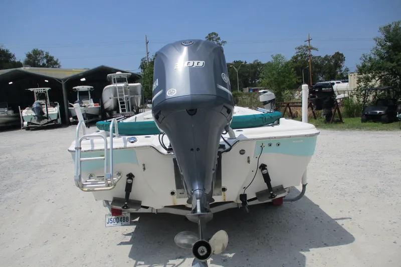 Slide: The Image of 2016 BLUEWAVE 24 Pure Bay boat with Yamaha outboard motor, parked outdoors. - 11