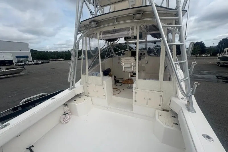 Slide: The Image of 2003 Albemarle 305 Express Fisherman boat, featuring spacious deck and fishing equipment. - 12