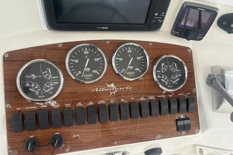 Slide: The Image of Dashboard of a 2003 Albemarle 305 Express Fisherman boat with gauges and controls. - 23