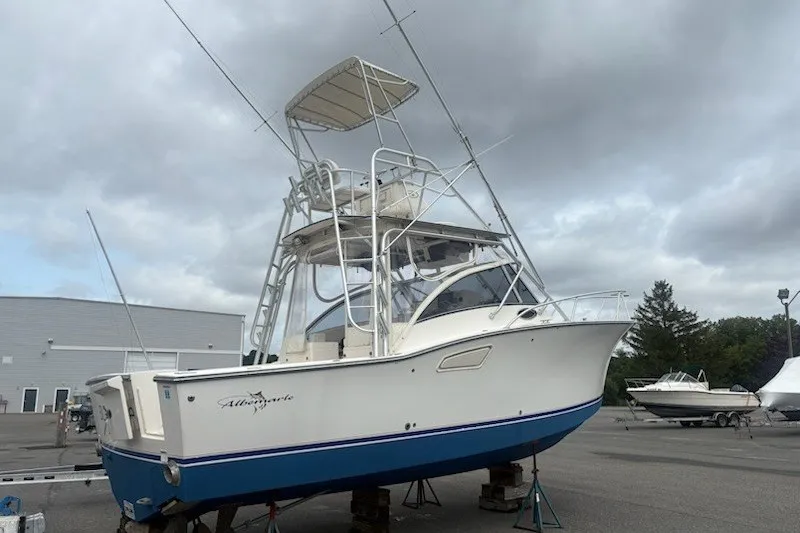 Slide: The Image of 2003 Albemarle 305 Express Fisherman boat on stands, with overcast sky background. - 5