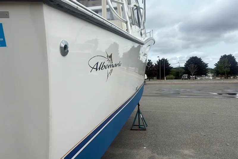 Slide: The Image of 2003 Albemarle 305 Express Fisherman boat on land, showcasing sleek white hull design. - 3