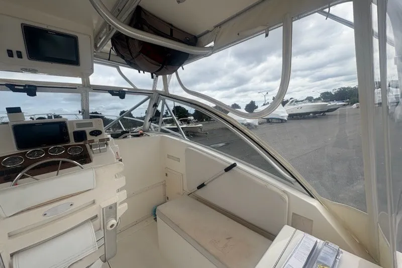 Slide: The Image of 2003 Albemarle 305 Express Fisherman boat interior with navigation equipment and seating. - 21