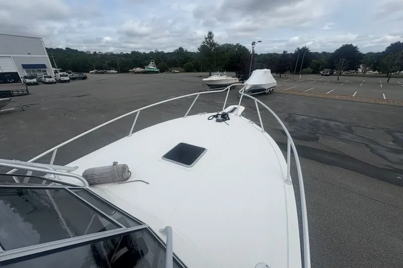 Slide: The Image of 2003 Albemarle 305 Express Fisherman boat on a trailer in a parking lot. - 14