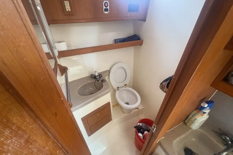 Slide: The Image of Bathroom interior of 2003 Albemarle 305 Express Fisherman boat, featuring sink and toilet. - 28