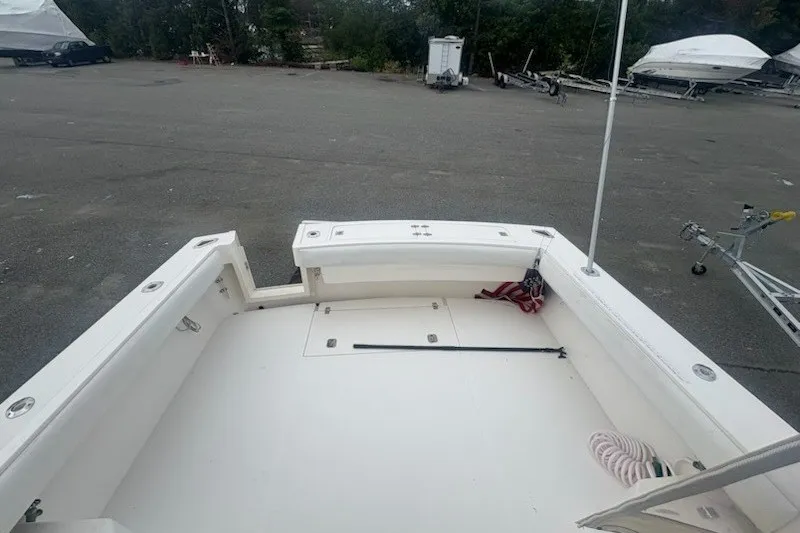 Slide: The Image of 2003 Albemarle 305 Express Fisherman boat deck, spacious and clean, in a parking area. - 13