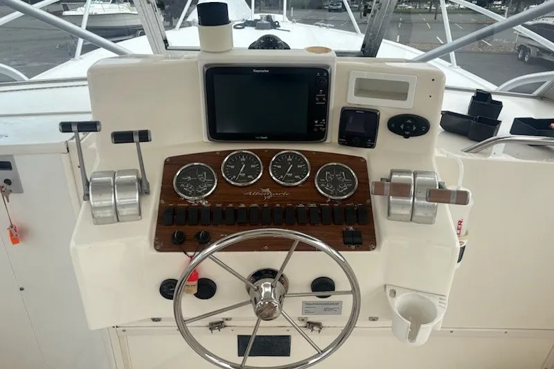 Slide: The Image of Helm of 2003 Albemarle 305 Express Fisherman with gauges and navigation equipment. - 22