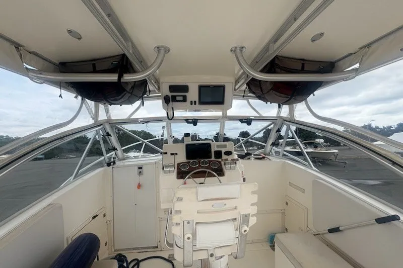 Slide: The Image of 2003 Albemarle 305 Express Fisherman boat cockpit with steering wheel and navigation equipment. - 20