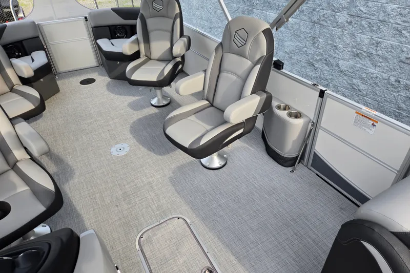 Slide: The Image of The image shows the interior of a 2027 South Bay SS224QC3.O pontoon boat with gray seating. - 6
