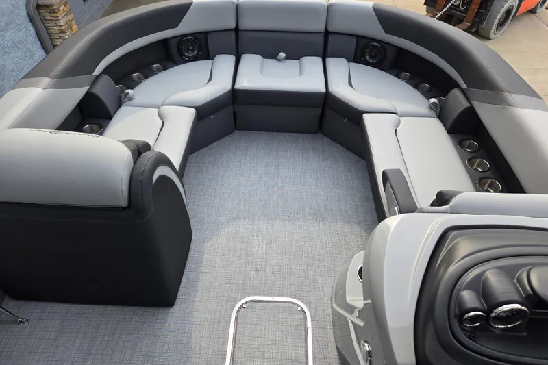 Slide: The Image of The image shows the interior of a modern pontoon boat with gray and black seating. - 13