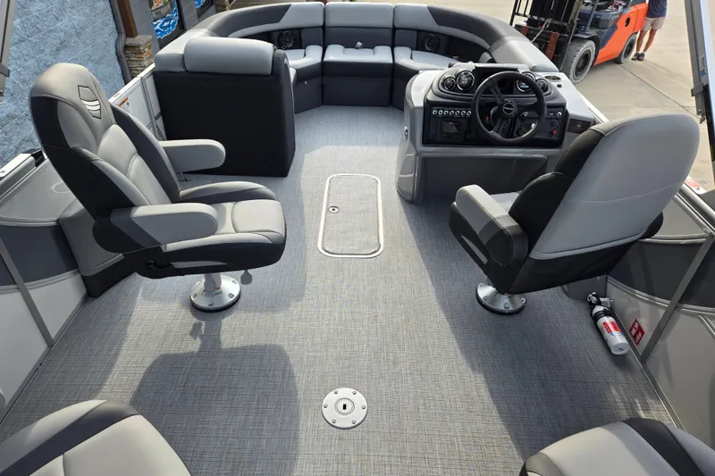 Slide: The Image of The image shows the interior of a modern pontoon boat with gray seating and a helm station. - 12