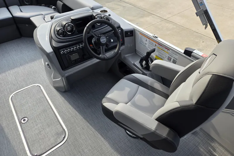 Slide: The Image of The image shows the cockpit of a modern pontoon boat with gray seats and a sleek dashboard. - 10