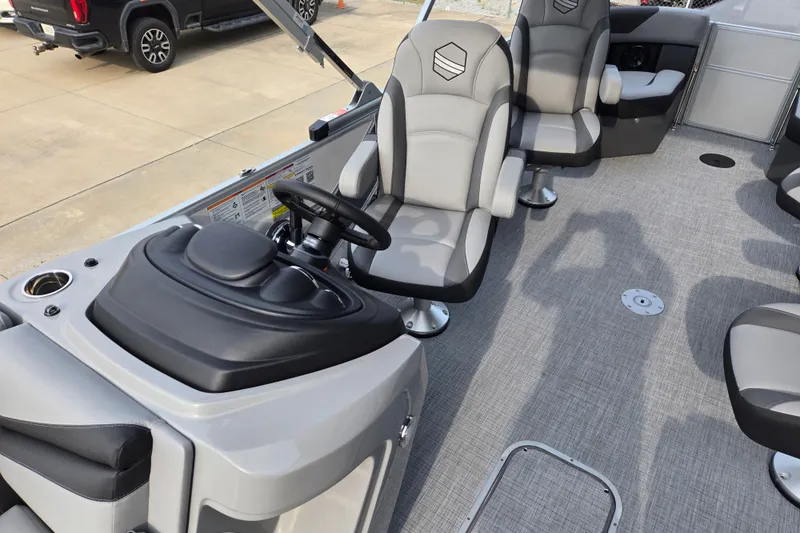 Slide: The Image of The image shows the interior of a modern pontoon boat with gray seats and a sleek helm. - 7