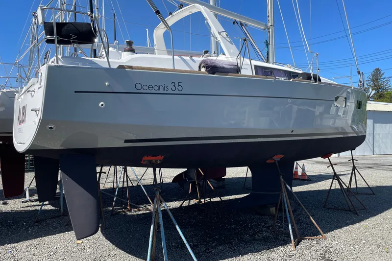 Slide: The Image of 2016 Beneteau Oceanis 35 sailboat on stands, displayed outdoors under clear blue sky. - 4