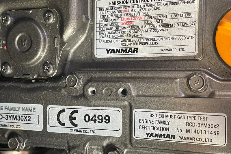 Slide: The Image of Yanmar engine label on a 2016 Beneteau Oceanis 35, showing emission control information. - 44
