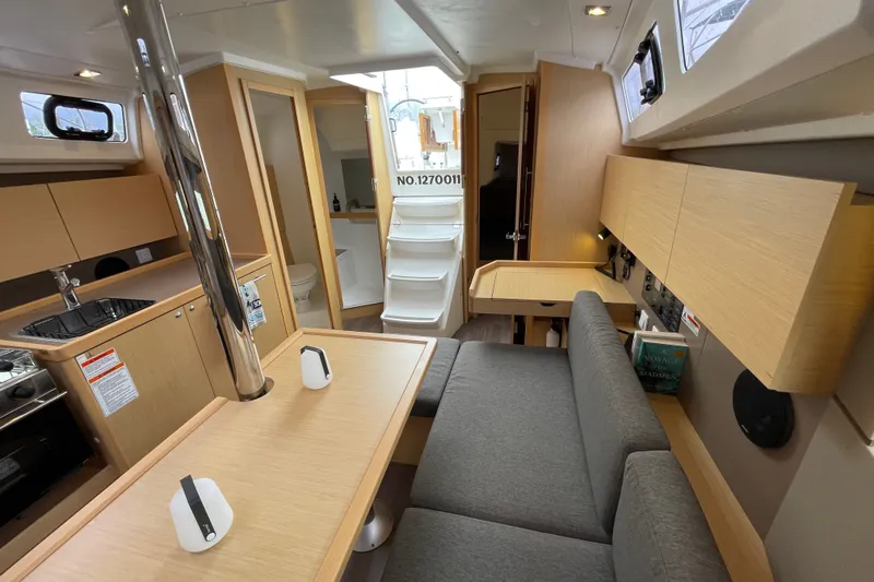 Slide: The Image of Interior of 2016 Beneteau Oceanis 35 sailboat, featuring modern kitchen and cozy seating area. - 25