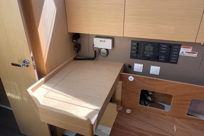 Slide: The Image of Interior view of 2016 Beneteau Oceanis 35 sailboat navigation station with control panel. - 38