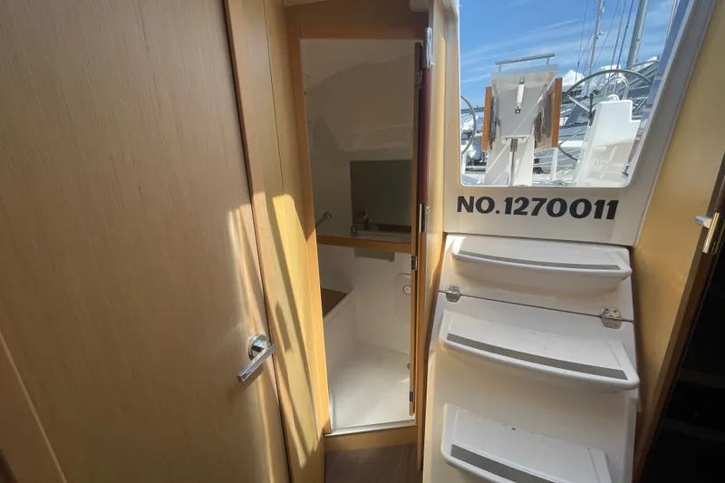 Slide: The Image of Interior view of 2016 Beneteau Oceanis 35 sailboat with stairs and cabin entrance. - 20