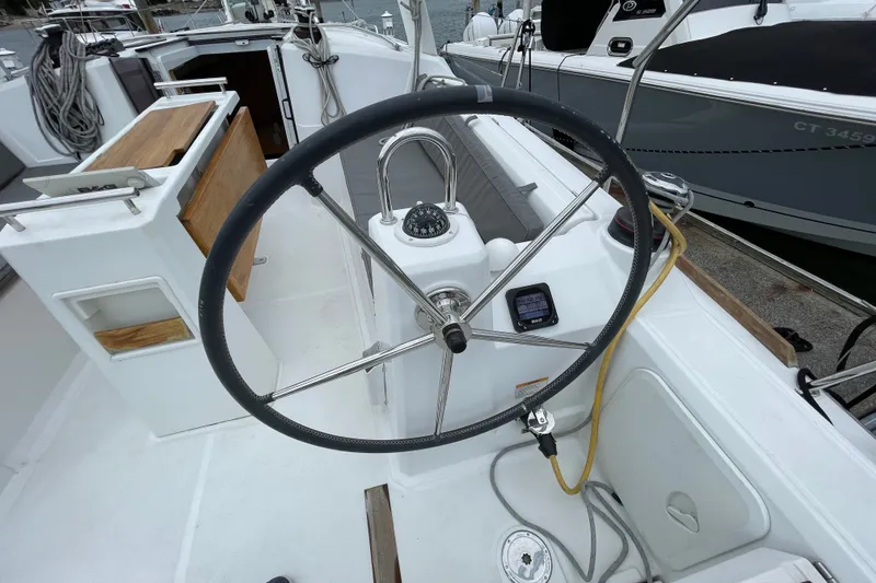 Slide: The Image of Steering wheel of a 2016 Beneteau Oceanis 35 sailboat, featuring navigation instruments. - 11