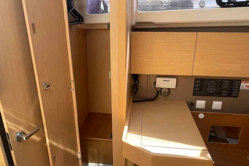 Slide: The Image of Interior of 2016 Beneteau Oceanis 35 yacht with wooden cabinetry and navigation panel. - 42