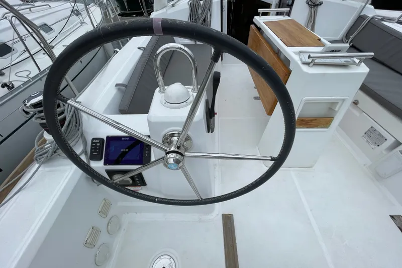 Slide: The Image of 2016 Beneteau Oceanis 35 yacht cockpit with steering wheel and navigation equipment. - 12