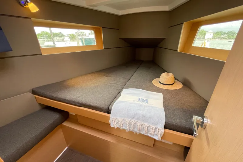 Slide: The Image of Cozy cabin interior of 2016 Beneteau Oceanis 35 yacht with windows and decor. - 33