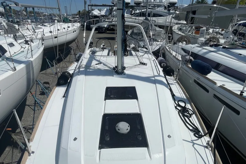 Slide: The Image of 2016 Beneteau Oceanis 35 sailboat docked among other yachts in a marina. - 18