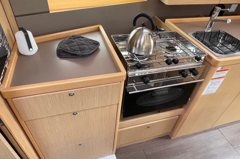 Slide: The Image of Compact kitchen in 2016 Beneteau Oceanis 35 yacht with stove, kettle, and sink. - 31