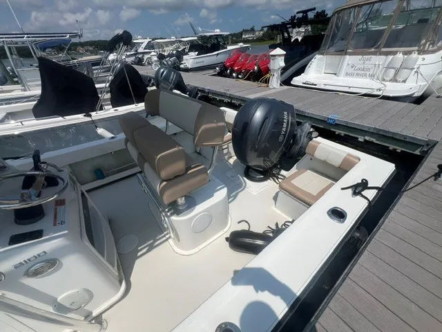 Slide: The Image of A 2018 Parker 2100 Deep Vee boat docked. It features a Yamaha outboard motor. - 3