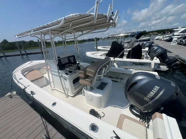 The Image of A 2018 Parker 2100 Deep Vee boat docked. It features a T-top and a Yamaha engine. - 2