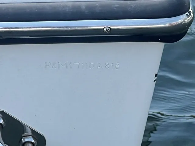 Slide: The Image of Close-up of the hull of a 2018 Parker 2100 Deep Vee boat on the water. - 9