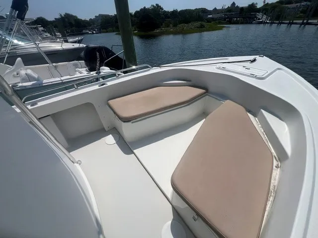 Slide: The Image of The image shows the bow area of a 2018 Parker 2100 Deep Vee boat with cushioned seating. - 7
