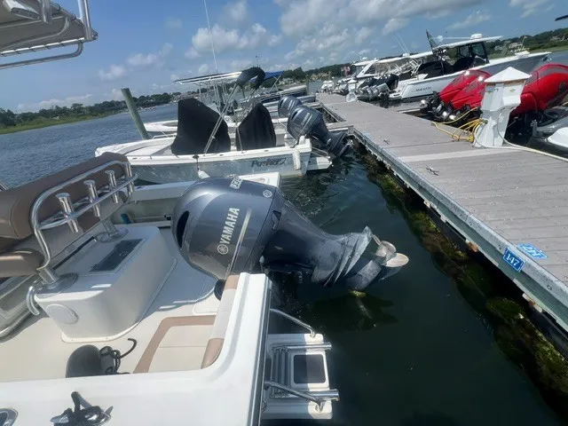 Slide: The Image of A 2018 Parker 2100 Deep Vee boat is docked. It features a Yamaha outboard motor. - 8