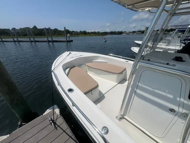 Slide: The Image of A 2018 Parker 2100 Deep Vee docked. It features an open deck with seating. - 4