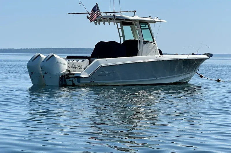 Slide: The Image of 2024 Boston Whaler 250 Outrage boat on calm water with dual Mercury engines. - 1