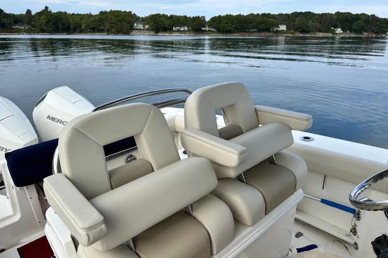 Slide: The Image of 2024 Boston Whaler 250 Outrage boat seats with scenic water view. - 14