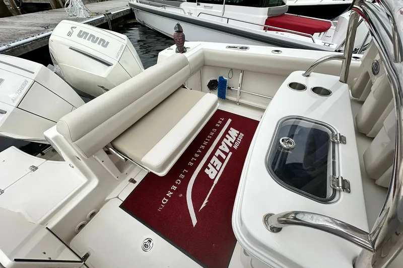 Slide: The Image of 2024 Boston Whaler 250 Outrage boat interior with seating and engine view. - 17