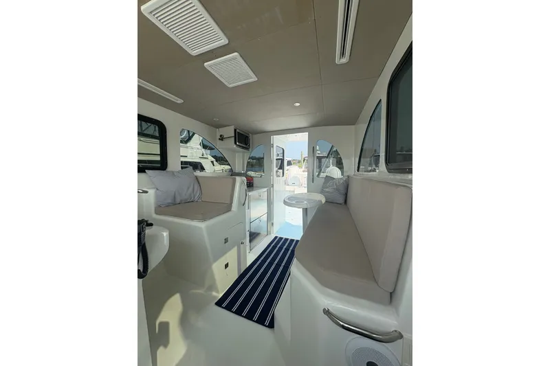 Slide: The Image of Interior of 2023 Millenium 37 Walk Around Fly Bridge Sportfish, featuring seating and modern design. - 61