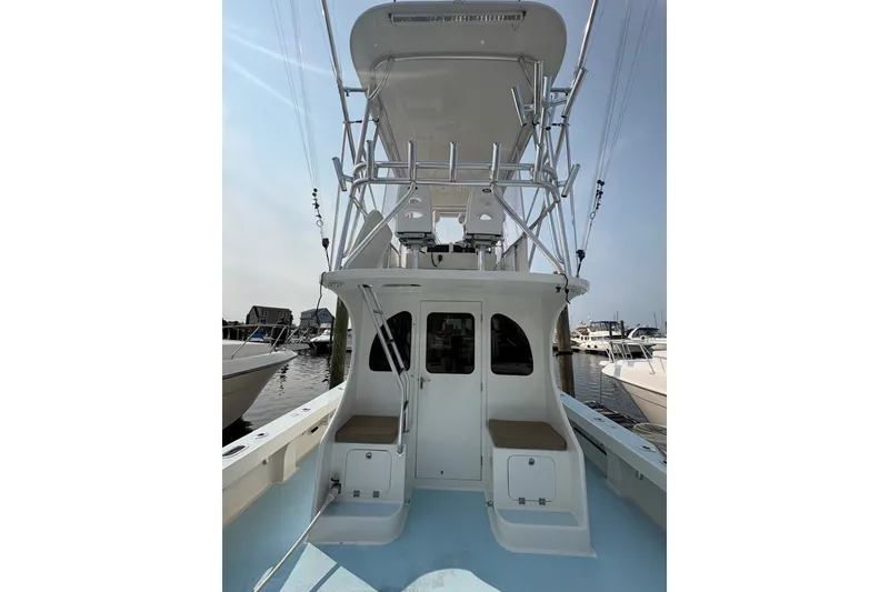 Slide: The Image of 2023 Millenium 37 Walk Around Fly Bridge Sportfish boat docked at marina. - 37
