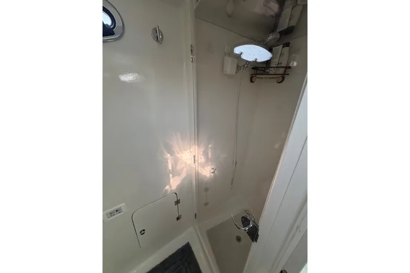 Slide: The Image of 2023 Millenium 37 Walk Around Fly Bridge Sportfish shower interior with modern fixtures. - 59